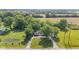 Aerial view of home surrounded by lush greenery and a circular driveway at 4305 Five Points Rd, Indianapolis, IN 46239