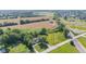 Home aerial view with paved driveway, surrounding greenery and adjacent agricultural fields at 4305 Five Points Rd, Indianapolis, IN 46239