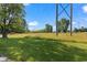 Expansive grass backyard with a few tall trees, power lines and vegetation at 4305 Five Points Rd, Indianapolis, IN 46239