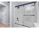 Bathroom with modern sliding glass doors enclosing a tub-shower combination at 4305 Five Points Rd, Indianapolis, IN 46239