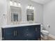 Bathroom with double sink vanity, gold fixtures, and bright lighting at 4305 Five Points Rd, Indianapolis, IN 46239