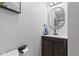 Charming bathroom featuring a dark wood vanity, oval mirror, and contemporary fixtures at 4305 Five Points Rd, Indianapolis, IN 46239