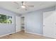 Well-lit bedroom with natural light, ceiling fan, and closet at 4305 Five Points Rd, Indianapolis, IN 46239