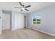 Bedroom with closet space, ceiling fan, and a large window overlooking the yard at 4305 Five Points Rd, Indianapolis, IN 46239