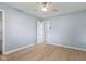 This bedroom features light, airy walls, a ceiling fan, and wood-look flooring at 4305 Five Points Rd, Indianapolis, IN 46239