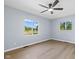Bedroom with light grey walls, wood flooring, and lots of natural light at 4305 Five Points Rd, Indianapolis, IN 46239