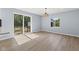 Bright dining area with sleek wood floors, modern lighting, and sliding glass doors to the backyard at 4305 Five Points Rd, Indianapolis, IN 46239