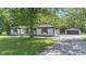 Charming home with white painted bricks, black accents, shutters, and a paved driveway at 4305 Five Points Rd, Indianapolis, IN 46239