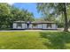Charming ranch-style home with freshly painted white brick, black trim, and lovely, landscaped yard at 4305 Five Points Rd, Indianapolis, IN 46239