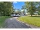 Charming ranch-style home with freshly painted white brick, black trim, and lovely, landscaped yard at 4305 Five Points Rd, Indianapolis, IN 46239