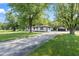 Charming ranch-style home with freshly painted white brick, black trim, and lovely, landscaped yard at 4305 Five Points Rd, Indianapolis, IN 46239
