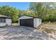 A two-car garage featuring white siding and a black door at 4305 Five Points Rd, Indianapolis, IN 46239