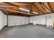 Spacious two car garage featuring a concrete floor, overhead lighting, and a back door at 4305 Five Points Rd, Indianapolis, IN 46239