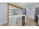 Kitchen island featuring wine cooler, cabinetry, and white countertop, creating an inviting space at 4305 Five Points Rd, Indianapolis, IN 46239