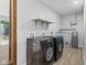 Large laundry room with washer and dryer and additional shelving at 4305 Five Points Rd, Indianapolis, IN 46239
