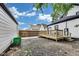 Backyard featuring a wooden deck, partial fencing, and a shed in the distance at 44 S Tremont St, Indianapolis, IN 46222
