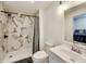 Bathroom featuring a shower with marble-style tile, modern fixtures, and a vanity with a sleek sink at 44 S Tremont St, Indianapolis, IN 46222