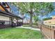 House with front porch, bordered by mature trees and picket fence, providing shade and privacy at 44 S Tremont St, Indianapolis, IN 46222