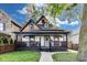 Charming home featuring a covered front porch and a well-maintained lawn, creating a welcoming curb appeal at 44 S Tremont St, Indianapolis, IN 46222