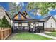 Inviting home with a classic design, showcasing a covered front porch and neat landscaping for a charming look at 44 S Tremont St, Indianapolis, IN 46222