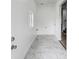 Hallway with marble-look tile flooring, leading to other rooms in the home. Clean and well-lit at 44 S Tremont St, Indianapolis, IN 46222