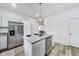 Bright kitchen features a central island with a stainless steel dishwasher and modern pendant lighting at 44 S Tremont St, Indianapolis, IN 46222