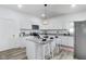Well-lit kitchen featuring stainless steel appliances, an island with seating, and ample cabinet space at 44 S Tremont St, Indianapolis, IN 46222