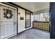 Covered front porch featuring a storm door and a decorative wreath, adding charm and protection to the home's entrance at 44 S Tremont St, Indianapolis, IN 46222