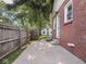 Brick house exterior with a fenced yard and patio, plus a detached garage with a blue door at 4523 Kingsley Dr, Indianapolis, IN 46205