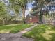 Spacious backyard with a well-maintained lawn, mature trees, and a brick home exterior at 4523 Kingsley Dr, Indianapolis, IN 46205