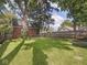 Large, fenced backyard featuring a well-maintained lawn and mature trees perfect for outdoor activities and privacy at 4523 Kingsley Dr, Indianapolis, IN 46205