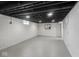 Unfinished basement featuring painted concrete walls, open ceiling with painted joists, and recessed lighting at 4523 Kingsley Dr, Indianapolis, IN 46205