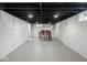 Open basement featuring painted walls, an exposed ceiling, and dining table creating an inviting multi-purpose area at 4523 Kingsley Dr, Indianapolis, IN 46205