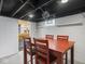 Finished basement featuring a dining table, an exposed ceiling, and a washbasin to create an inviting atmosphere at 4523 Kingsley Dr, Indianapolis, IN 46205