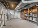 Unfinished basement with visible pipes, water heater, ductwork, and shelving for ample storage at 4523 Kingsley Dr, Indianapolis, IN 46205