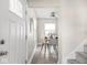 Open dining area with modern decor, adjacent to a stairway and exterior door at 4523 Kingsley Dr, Indianapolis, IN 46205