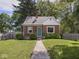 Charming brick home with a colorful front door and a well-maintained lawn at 4523 Kingsley Dr, Indianapolis, IN 46205