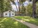 Detached garage with a blue door, flower boxes, and a well-maintained lawn at 4523 Kingsley Dr, Indianapolis, IN 46205