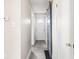 Hallway with white walls, grey tile floor, barn door, and view of the home's front door at 4523 Kingsley Dr, Indianapolis, IN 46205