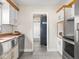 Updated kitchen with stainless steel appliances and a powder room door in view at 4523 Kingsley Dr, Indianapolis, IN 46205