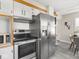 Updated kitchen with stainless steel appliances and white cabinets with wood trim at 4523 Kingsley Dr, Indianapolis, IN 46205