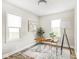 Bright office with modern desk, unique lamp, and natural light from two windows at 4523 Kingsley Dr, Indianapolis, IN 46205