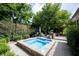 A luxurious backyard oasis featuring a hot tub surrounded by lush landscaping at 4976 Rockne Cir, Carmel, IN 46033