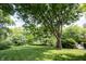 Lush green backyard with mature trees offering ample shade, ideal for outdoor enjoyment at 4976 Rockne Cir, Carmel, IN 46033