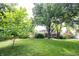 Beautiful backyard with mature trees and a well-maintained lawn, perfect for outdoor activities at 4976 Rockne Cir, Carmel, IN 46033