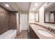 Bathroom featuring double vanity with granite countertop, tiled walls, and shower/tub combo at 4976 Rockne Cir, Carmel, IN 46033