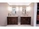 Bathroom featuring double vanities with granite countertops and contemporary lighting fixtures at 4976 Rockne Cir, Carmel, IN 46033