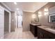 Bright bathroom featuring double vanities with granite countertops, modern lighting, and tile flooring at 4976 Rockne Cir, Carmel, IN 46033