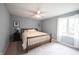 Bedroom with a ceiling fan, neutral carpeting, and a large window providing natural light at 4976 Rockne Cir, Carmel, IN 46033