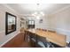 Dining room featuring hardwood floors, modern chandelier, and large wooden table at 4976 Rockne Cir, Carmel, IN 46033